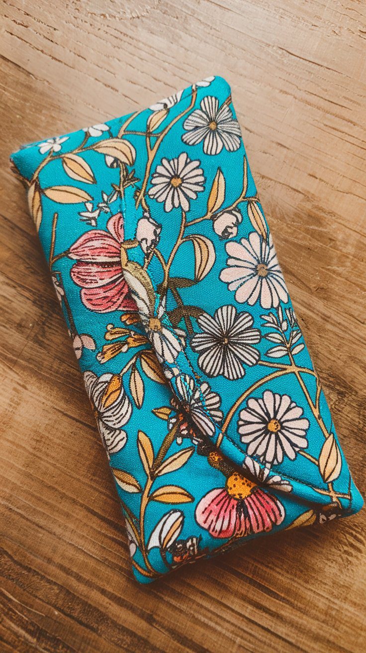 A soft handmade eyeglass case in patterned fabric with a snap closure, sewn as a personalized protective gift.